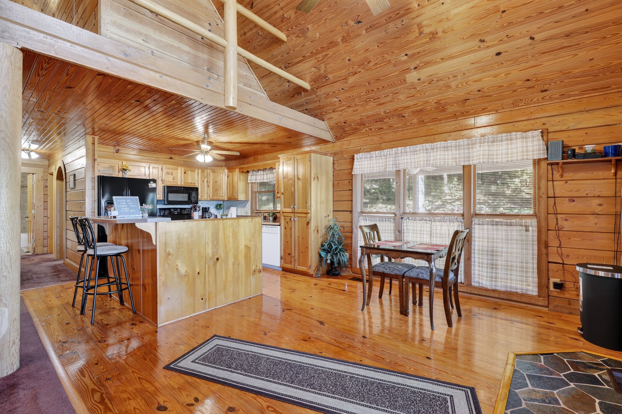 1794 Roberts Road Watertown, TN 37184 - Photo 23 of 38 a dining room with furniture floor to ceiling windows and wooden floor