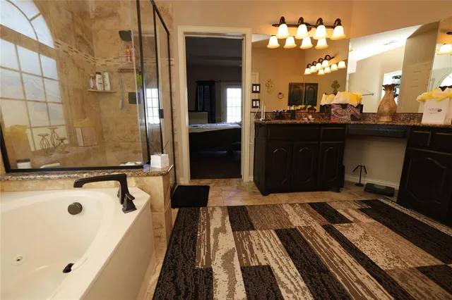 a white bath tub sitting in a bathroom next to a window