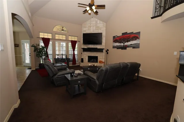 a living room with furniture a flat screen tv and a fireplace
