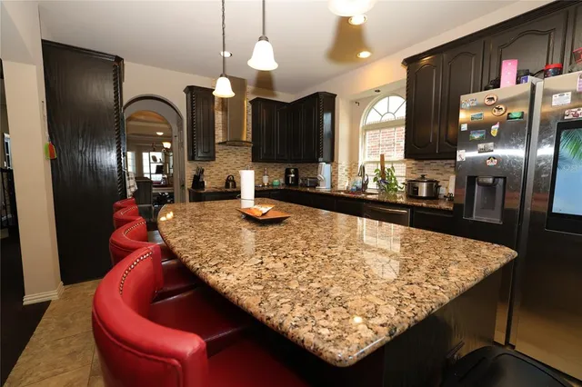 a large kitchen with a table and chairs