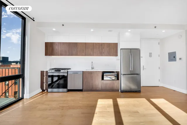 a kitchen with stainless steel appliances a refrigerator and a stove top oven