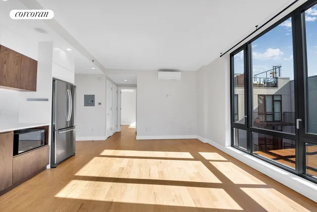 a view of an entryway with wooden floor