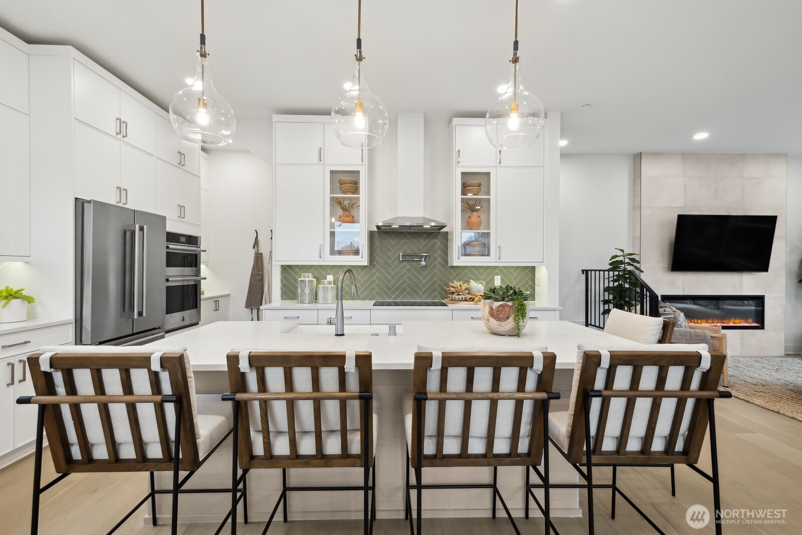 18923 99th Place Northeast, Unit A Bothell, WA 98011 - Photo 8 of 27 a kitchen with stainless steel appliances kitchen island granite countertop a dining table chairs refrigerator and microwave