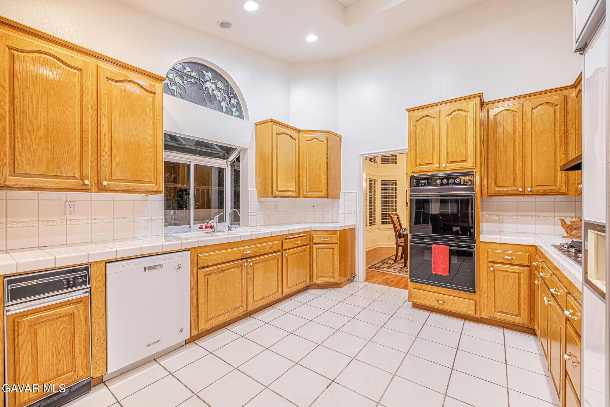 19809 Winged Foot Way Porter Ranch, CA 91326 - Photo 23 of 70 a kitchen with stainless steel appliances granite countertop a stove a sink and a microwave
