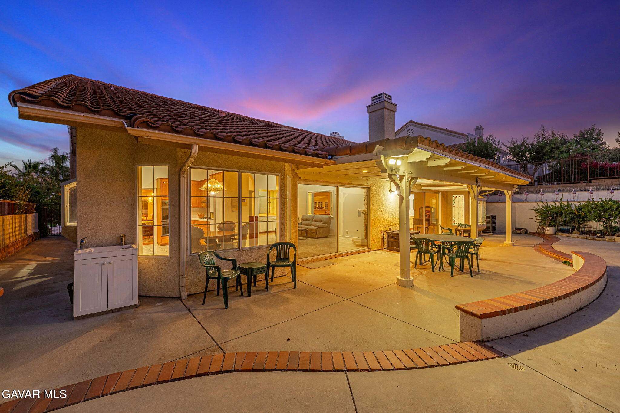 19809 Winged Foot Way Porter Ranch, CA 91326 - Photo 46 of 70 a view of a patio with couches table and chairs under an umbrella with a barbeque grill and couches