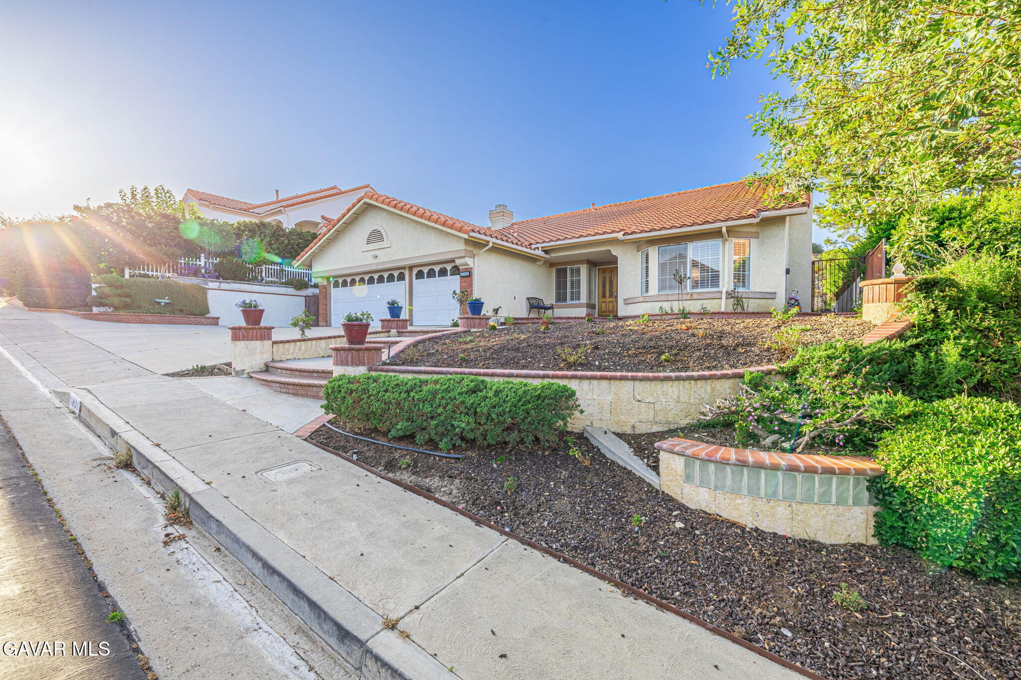 19809 Winged Foot Way Porter Ranch, CA 91326 - Photo 49 of 70 a front view of a house with a garden and plants