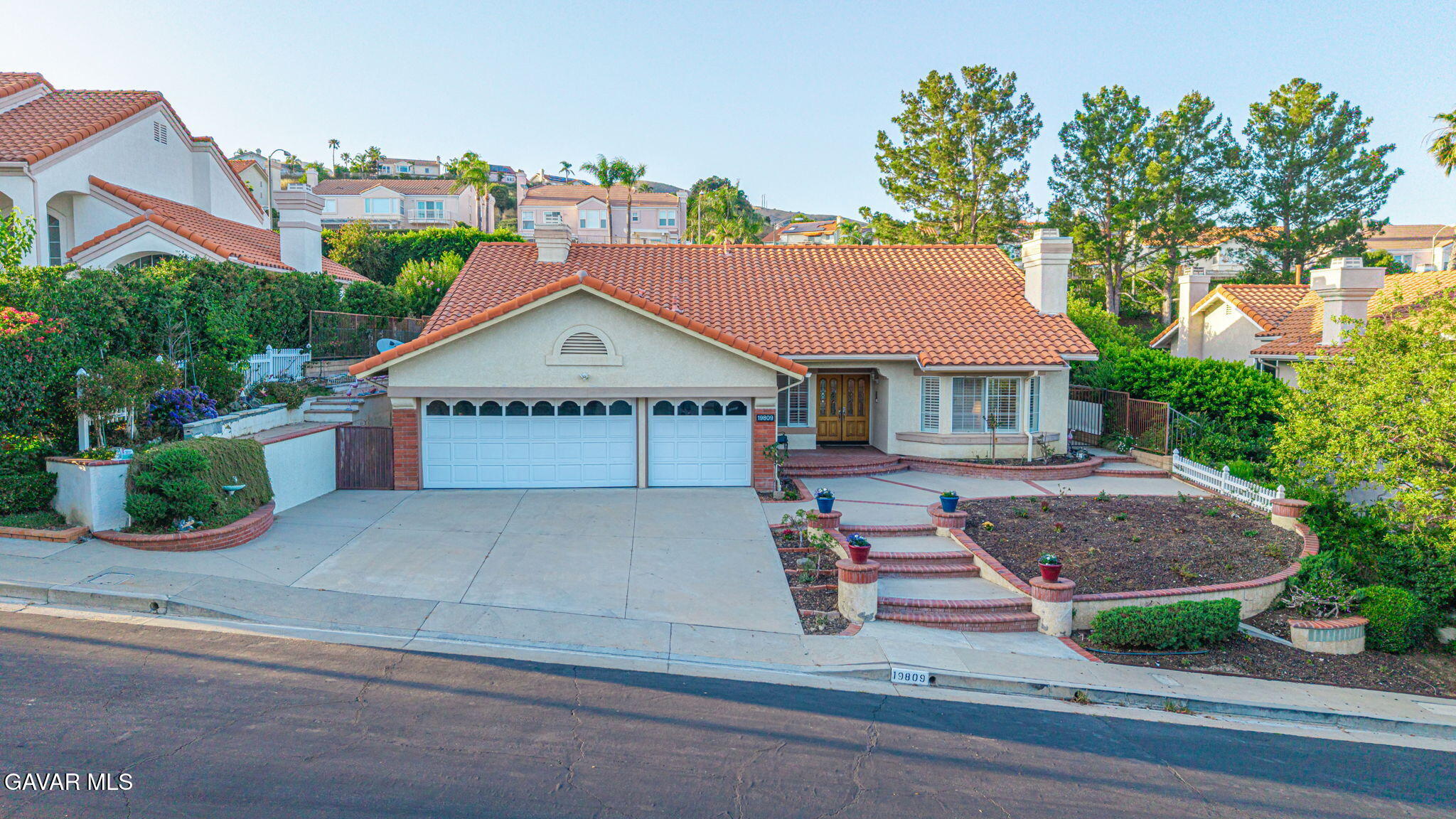 19809 Winged Foot Way Porter Ranch, CA 91326 - Photo 50 of 70 a front view of a house with garden