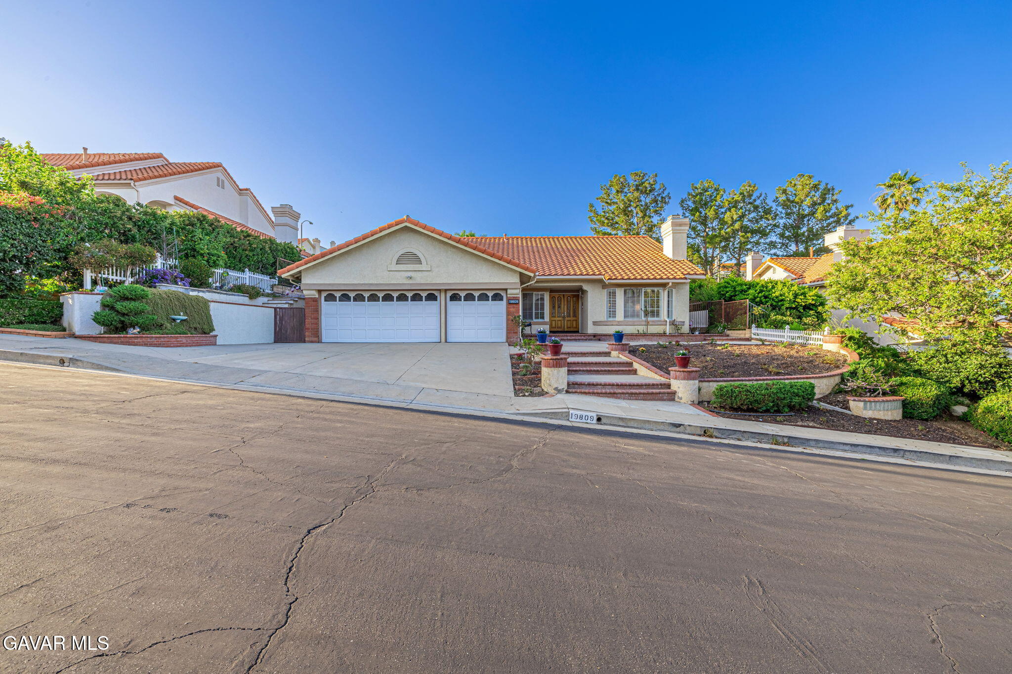 19809 Winged Foot Way Porter Ranch, CA 91326 - Photo 6 of 70 a view of a house with a yard and table and chairs under an umbrella