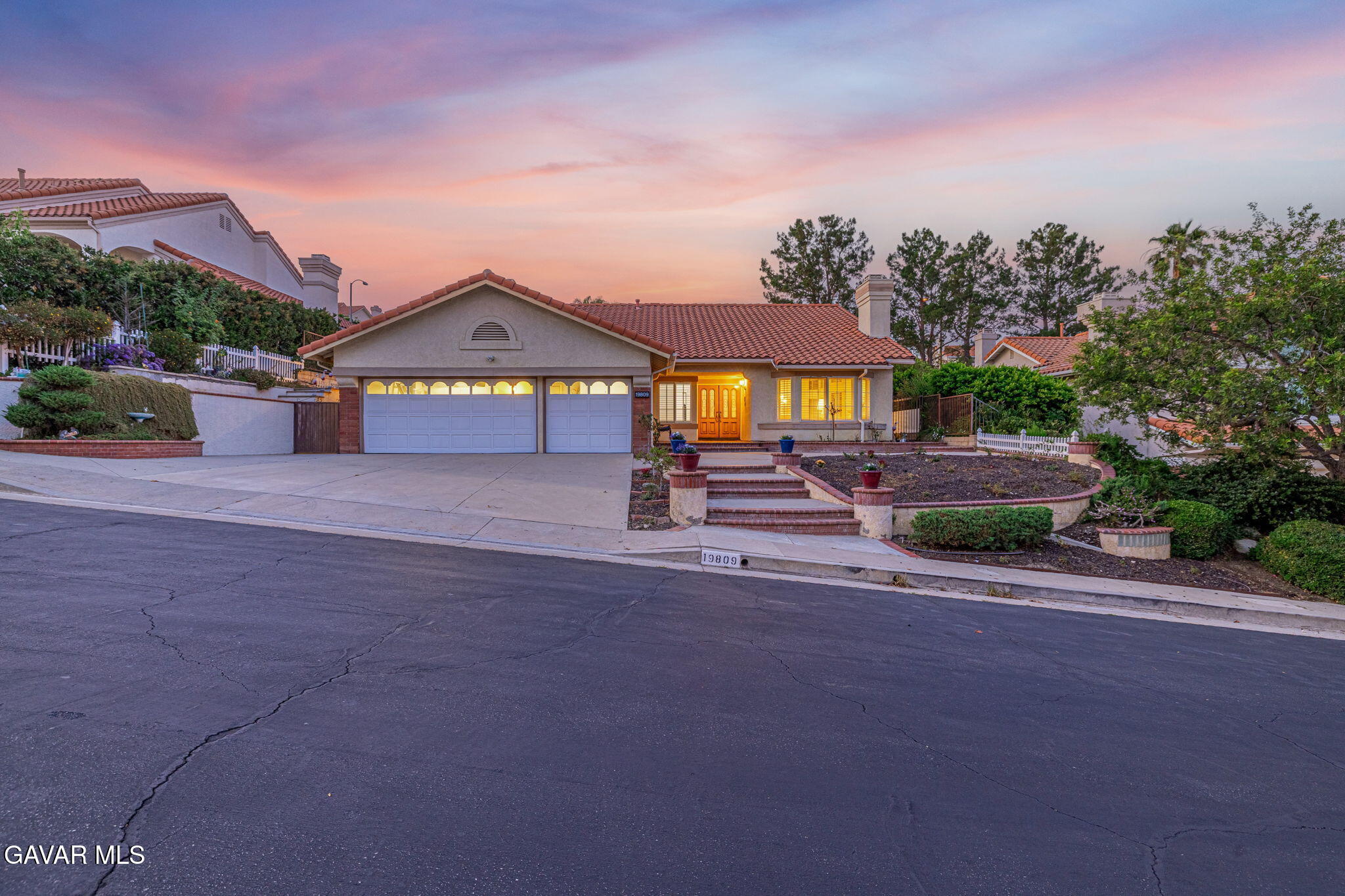 19809 Winged Foot Way Porter Ranch, CA 91326 - Photo 61 of 70 a front view of a house with a yard and garage