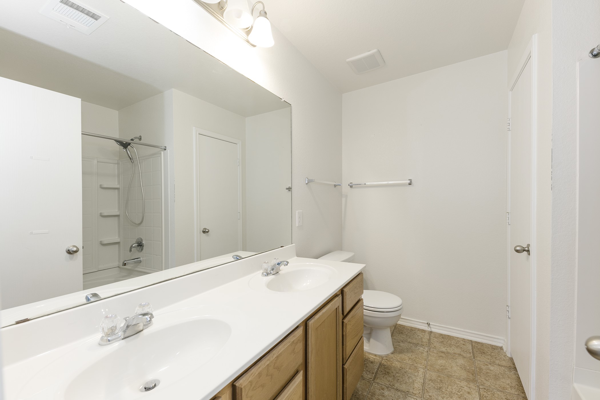1141 Renaissance Trail Round Rock, TX 78665 - Photo 9 of 23 Double vanity and a full-size mirror expand this bathroom's spacious feel.