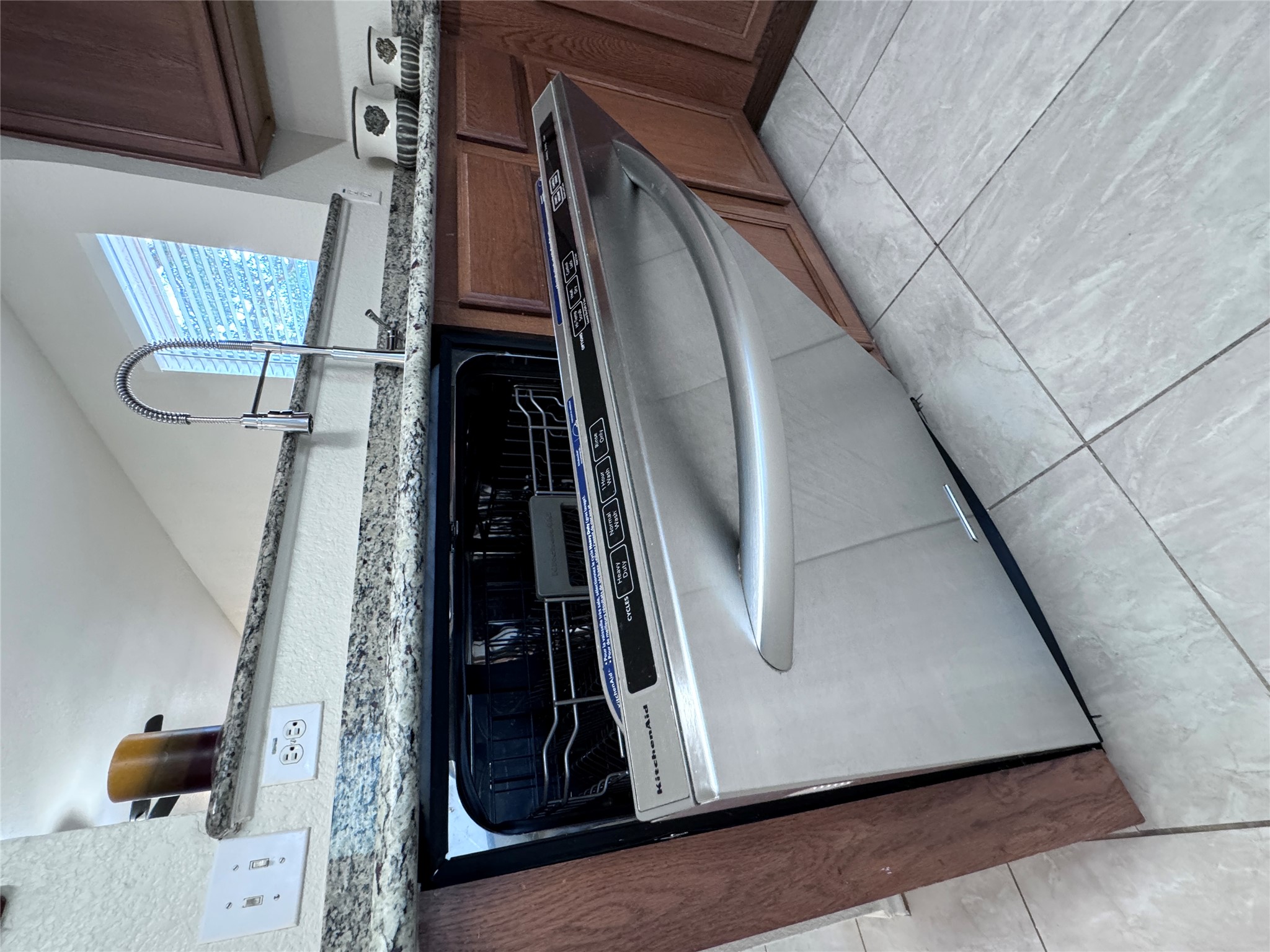 3411 Wickham Lane Austin, TX 78725 - Photo 16 of 20 Stainless steel dishwasher, deep sink and light granite countertops with dark wood finished cabinets