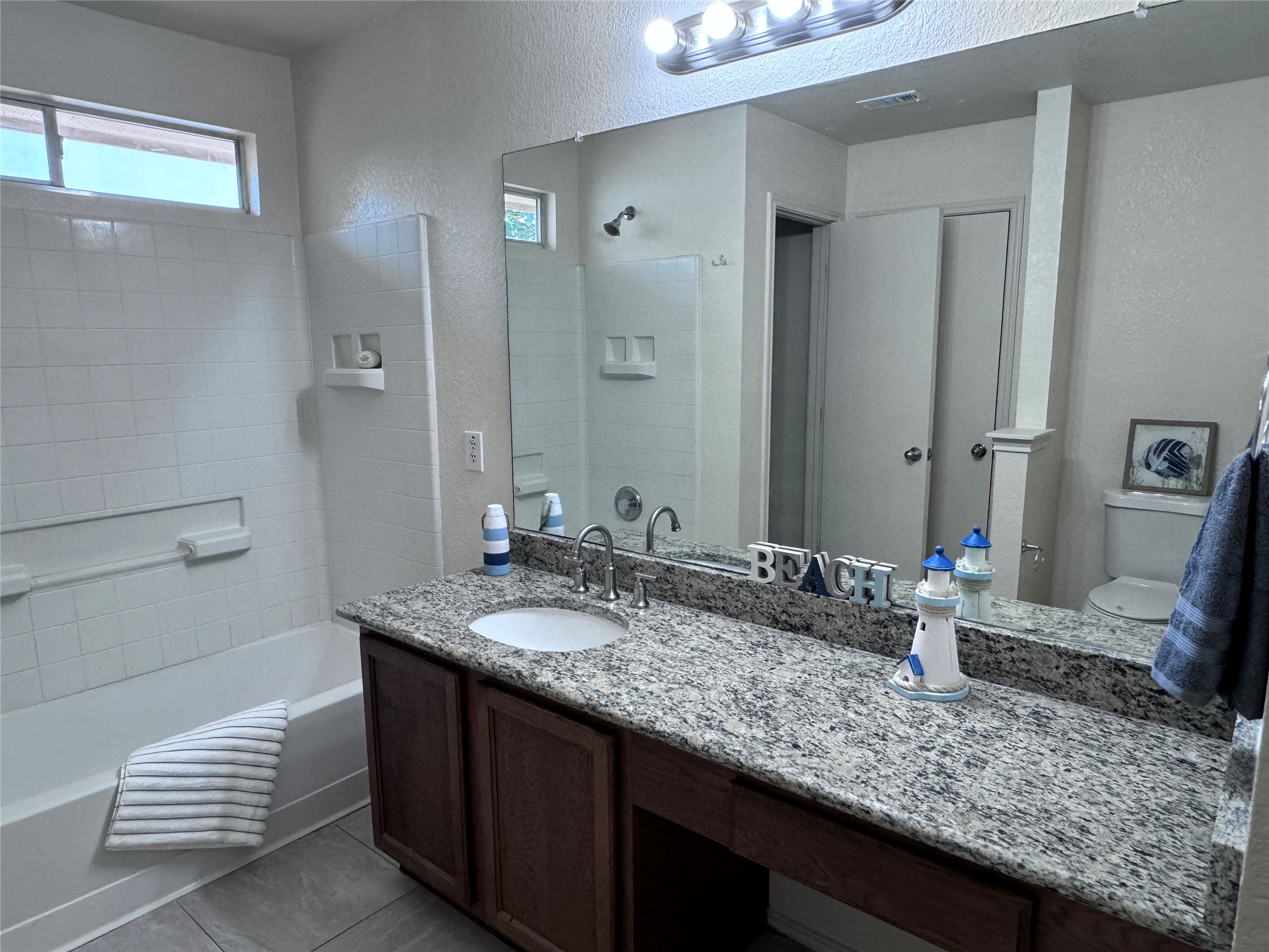 3411 Wickham Lane Austin, TX 78725 - Photo 10 of 20 Full bath with vanity with shower combination, and light ceramic tile patterned flooring
