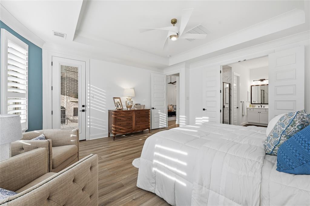 4409 Lk Vw Road Oak Point, TX 75068 - Photo 14 of 40 a spacious bedroom with a bed a couch and a chandelier