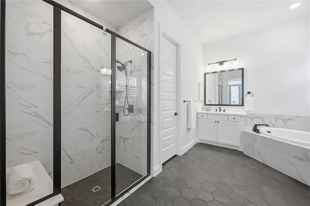 a spacious bathroom with a glass shower door and a sink