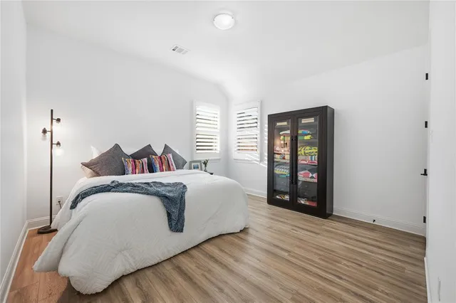 a spacious bedroom with a bed and window