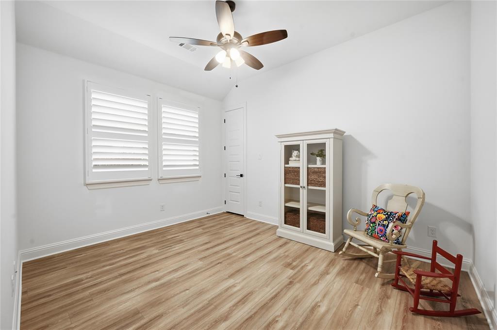 4409 Lk Vw Road Oak Point, TX 75068 - Photo 21 of 40 a view of a room with wooden floor and ceiling fan