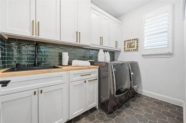 a kitchen with stainless steel appliances granite countertop a sink cabinets and a window