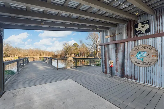 a view of a lake from a balcony with wooden floor