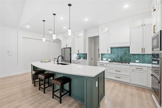 a kitchen with kitchen island a sink table and chairs
