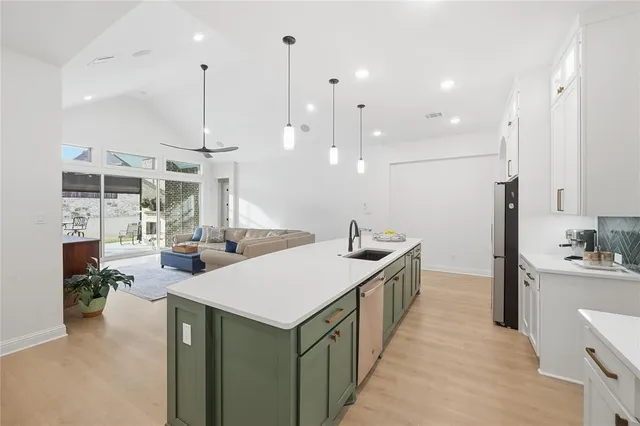 a kitchen with stainless steel appliances kitchen island a large island in the center