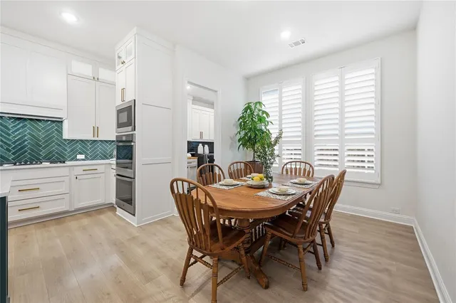 a dining room with furniture and window