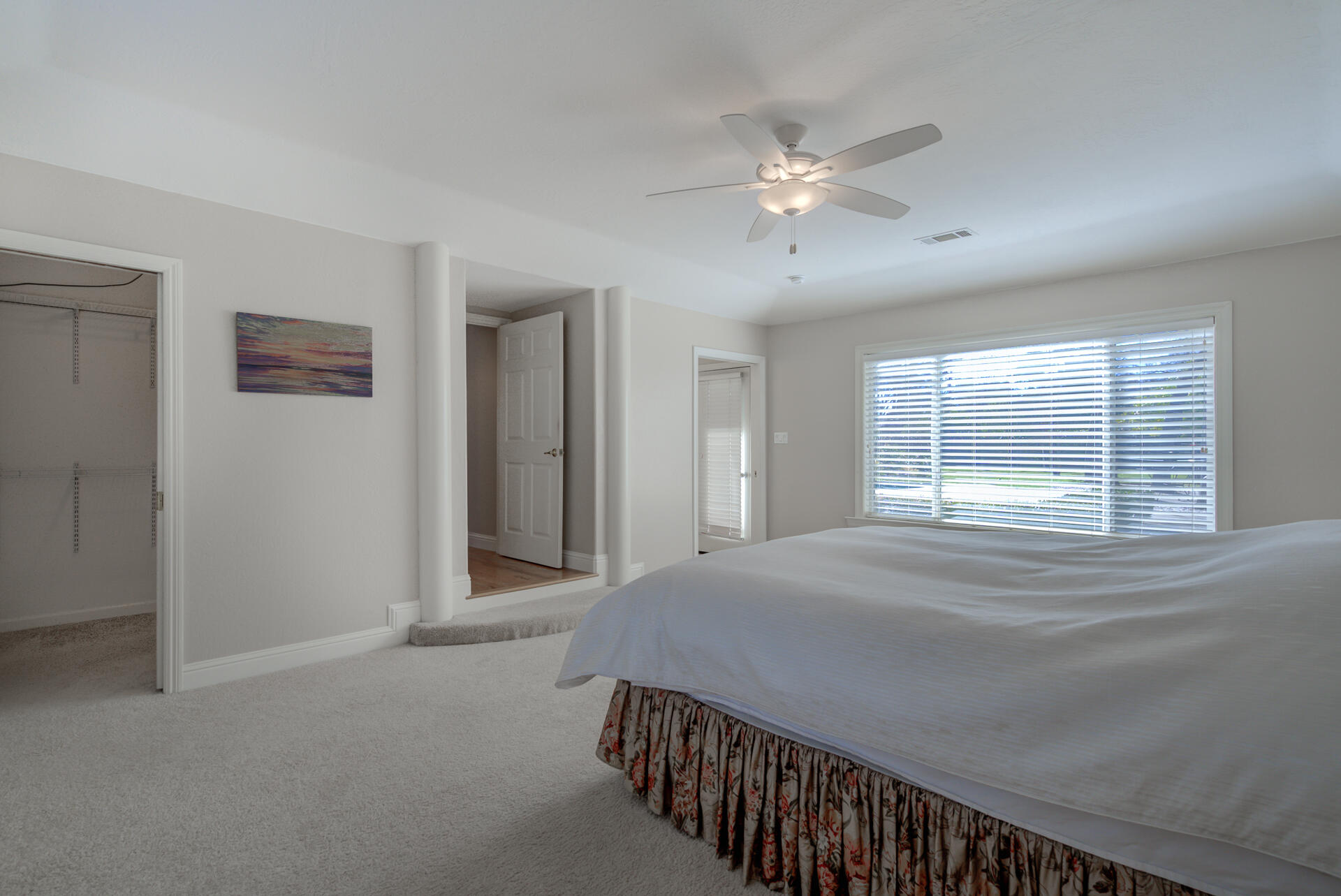 8614 Redbank Road Redding, CA 96001 - Photo 18 of 31 a bedroom with a large bed and a chandelier