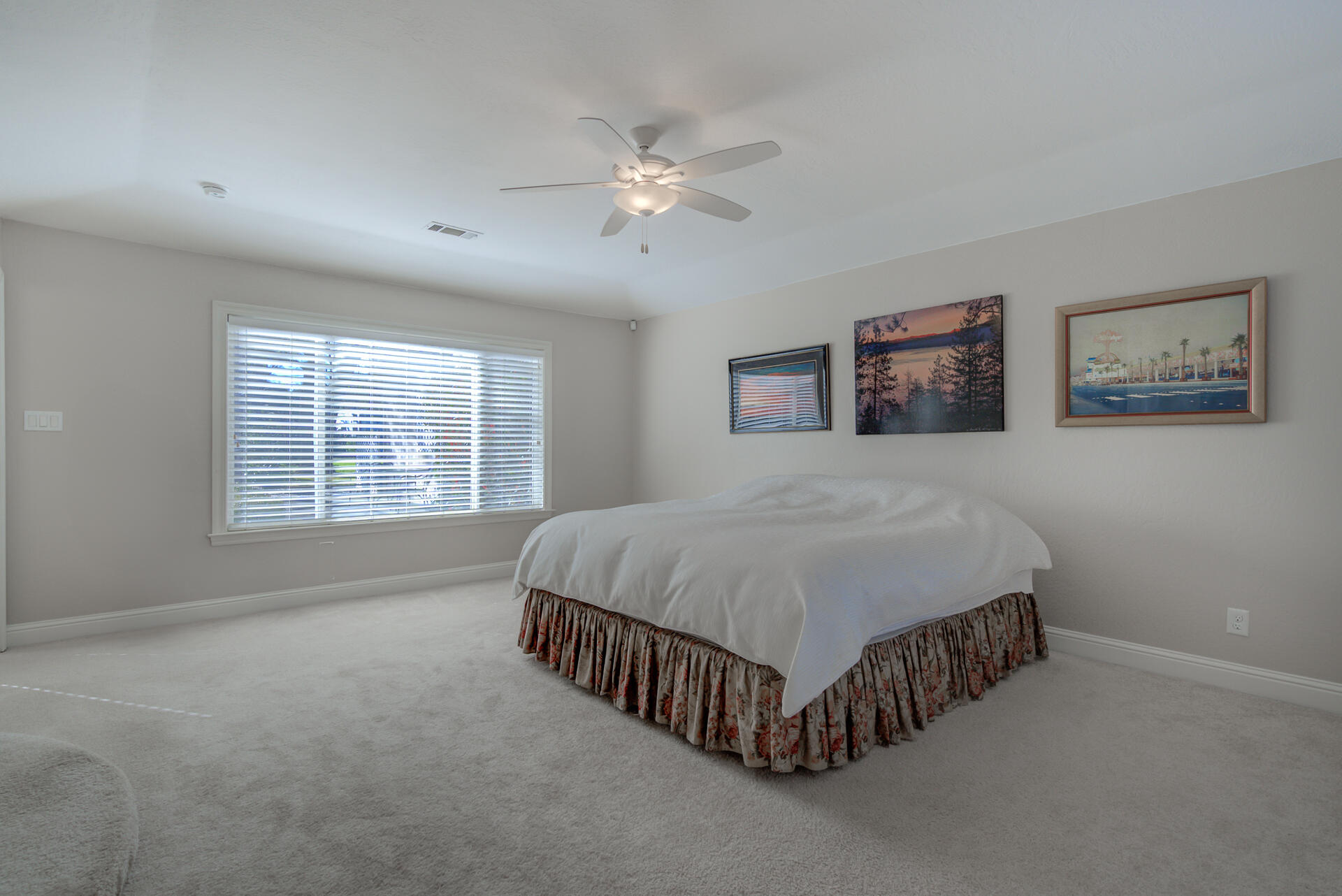 8614 Redbank Road Redding, CA 96001 - Photo 19 of 31 a spacious bedroom with a bed and a chandelier
