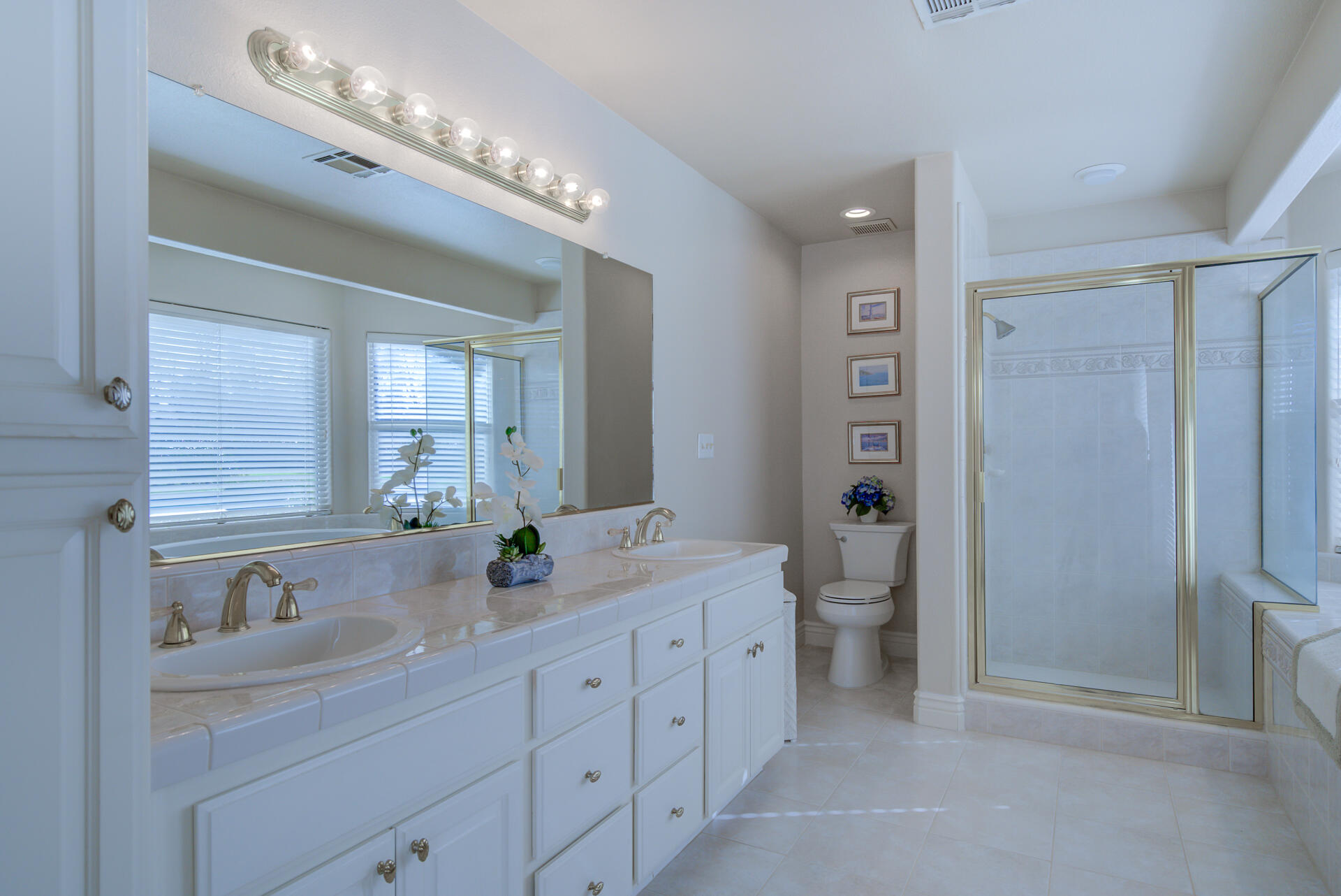 8614 Redbank Road Redding, CA 96001 - Photo 21 of 31 a bathroom with double vanity sinks a toilet a shower a vanity and a mirror