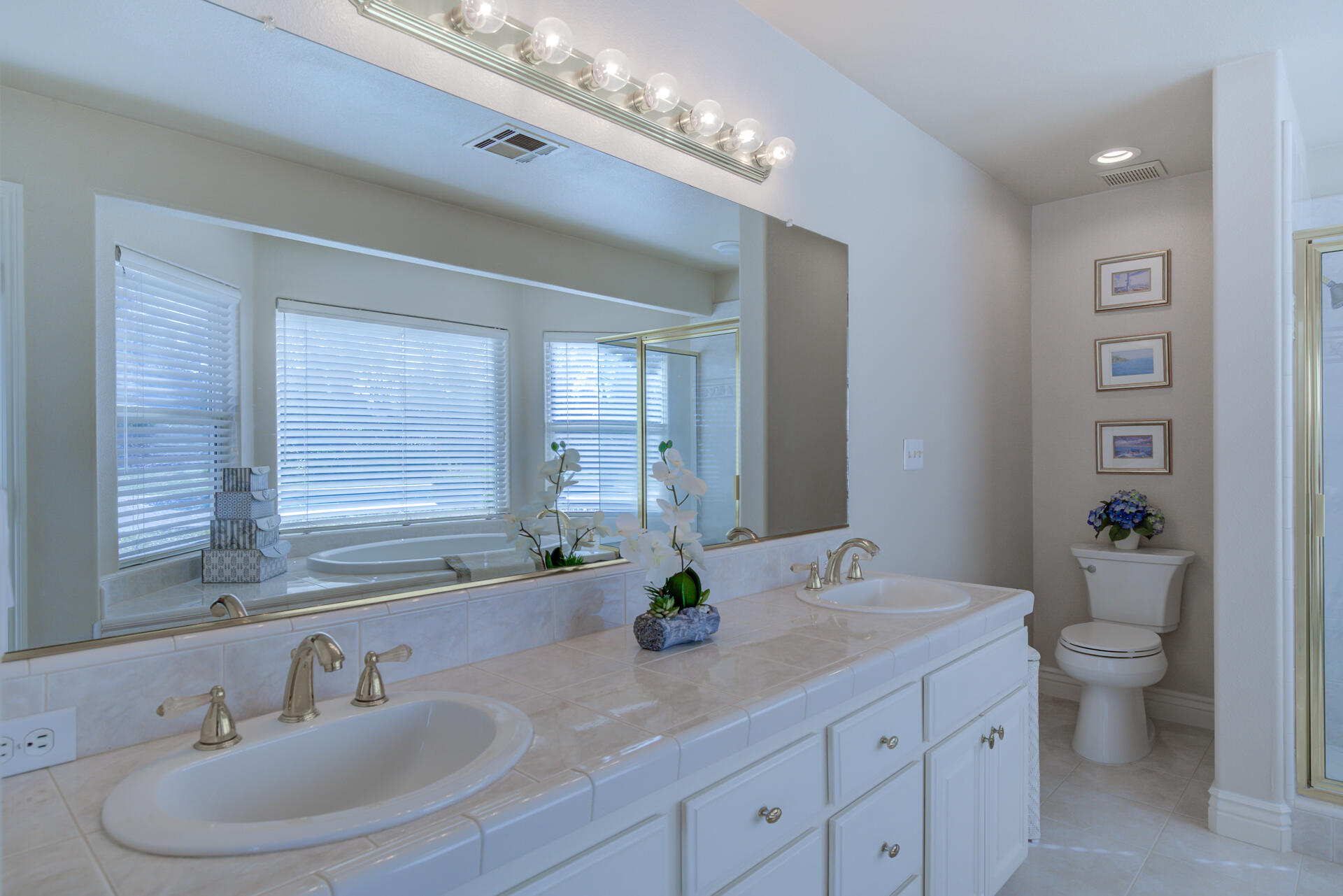 8614 Redbank Road Redding, CA 96001 - Photo 23 of 31 a bathroom with a double vanity sink toilet and a mirror