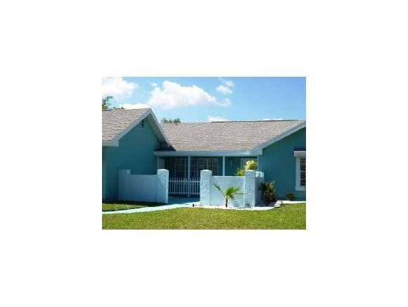 348 Ne Port Palm Bay, FL 32905 - Photo 1 of 7 a picture of a bench in front of house