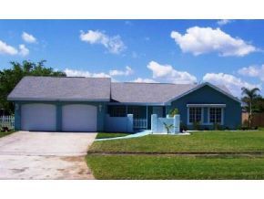 348 Ne Port Palm Bay, FL 32905 - Photo 2 of 7 a front view of a house with a yard