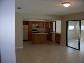 348 Ne Port Palm Bay, FL 32905 - Photo 5 of 7 a kitchen with stainless steel appliances a refrigerator and a sink