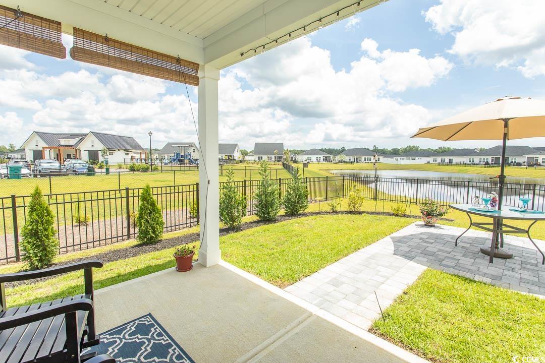 435 Rollins Drive Longs, SC 29568 - Photo 15 of 23 Fenced backyard with a residential view, a patio, and a water view