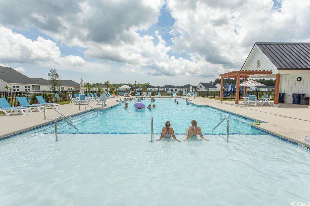 435 Rollins Drive Longs, SC 29568 - Photo 22 of 24 Community pool with a patio area, a residential view, and a pergola