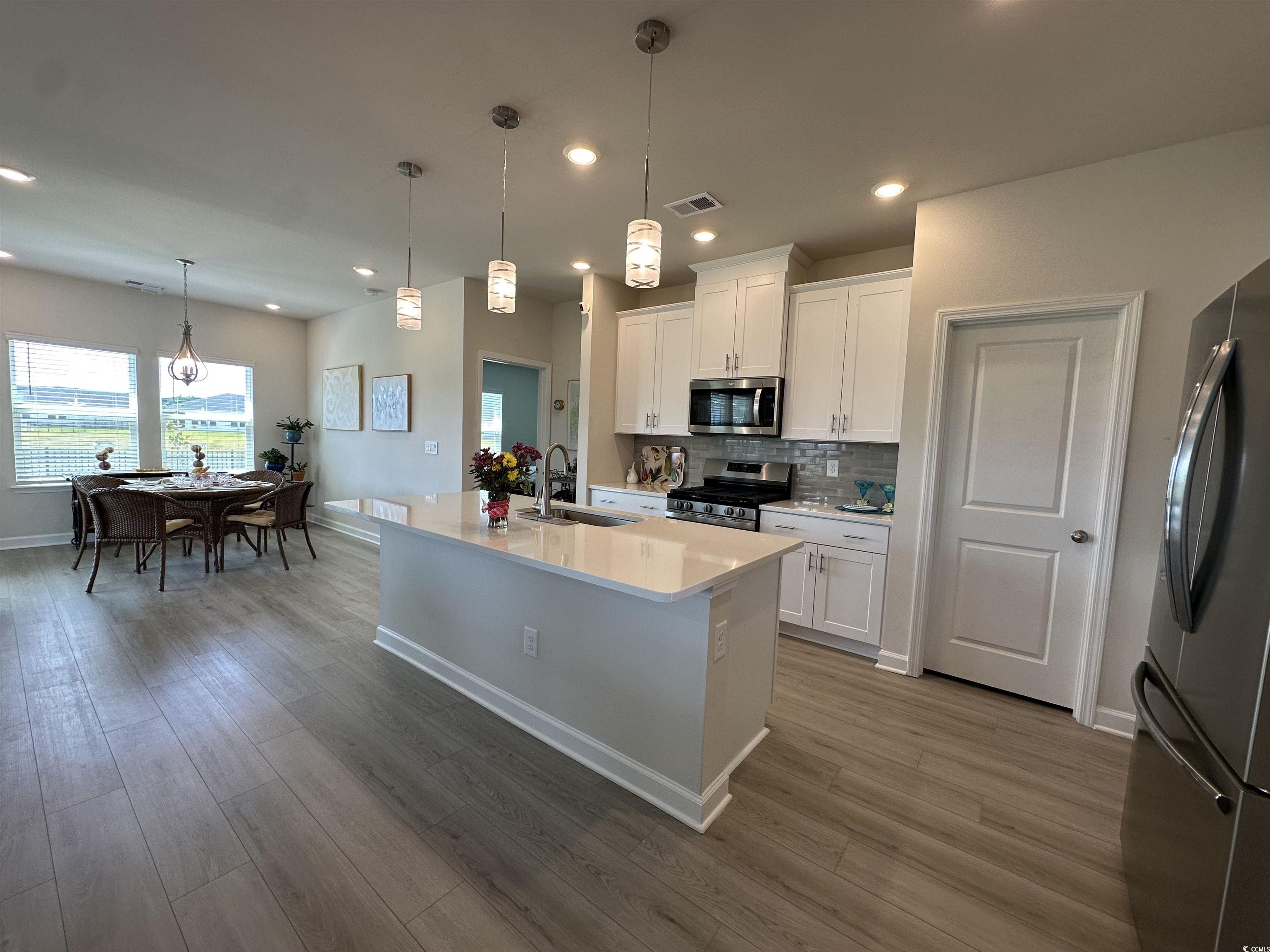 435 Rollins Drive Longs, SC 29568 - Photo 7 of 23 Kitchen featuring tasteful backsplash, decorative light fixtures, white cabinetry, stainless steel appliances, and recessed lighting