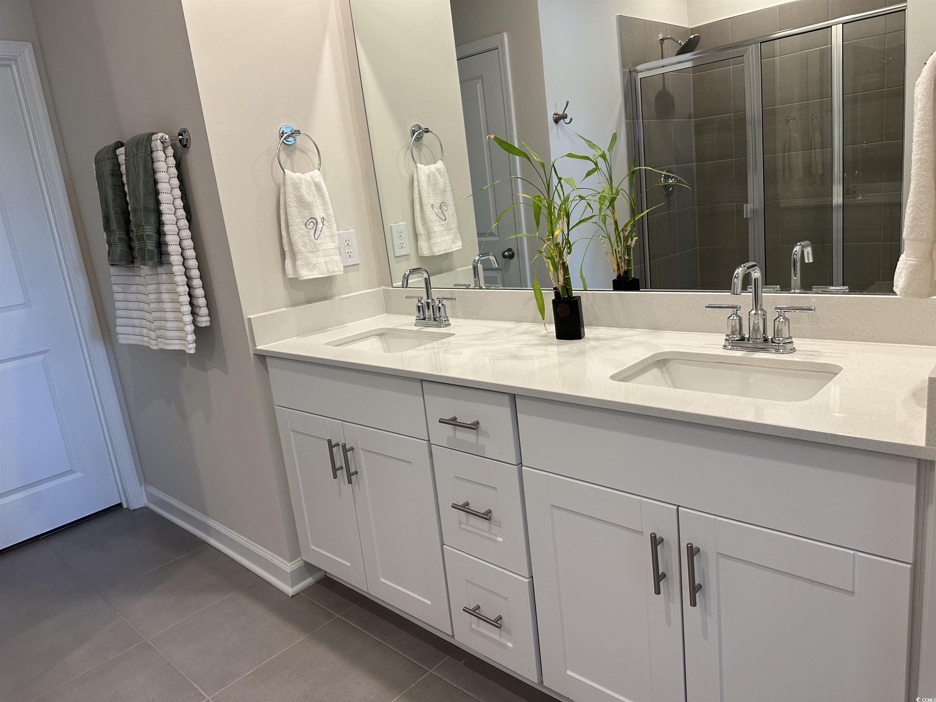 435 Rollins Drive Longs, SC 29568 - Photo 9 of 23 Full bathroom with double vanity, tile patterned floors, and a shower stall