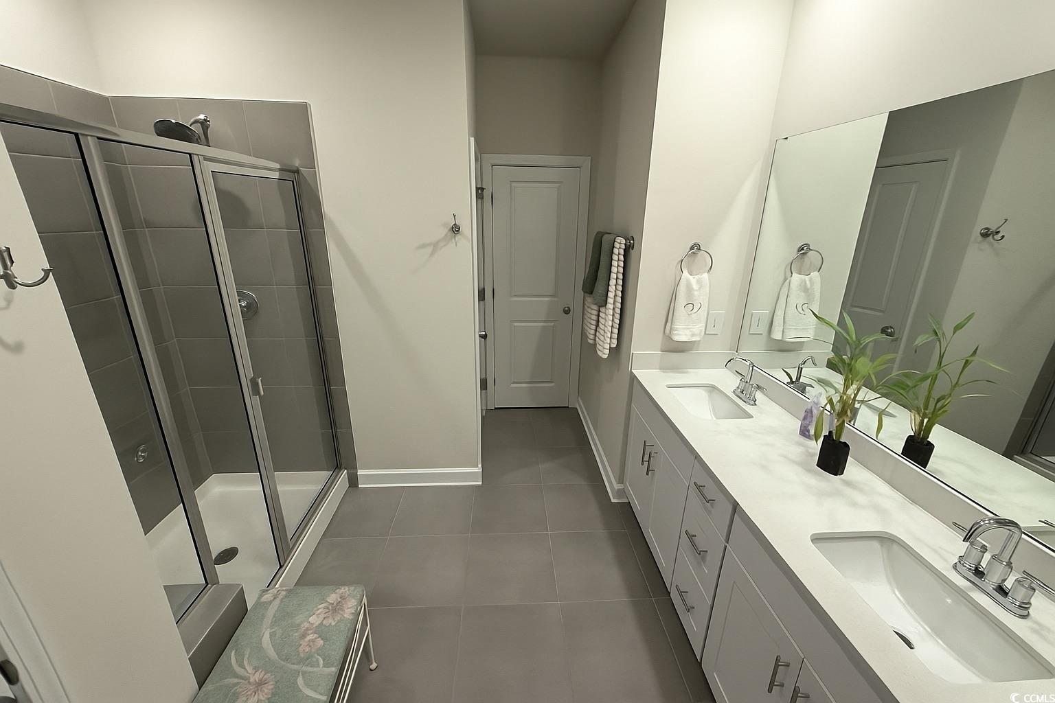 435 Rollins Drive Longs, SC 29568 - Photo 10 of 23 Bathroom featuring double vanity, a shower stall, and dark tile patterned flooring