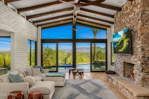a living room with furniture a flat screen tv and a fireplace