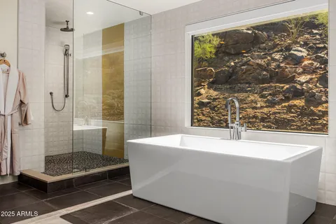 a bathroom with a bathtub and a shower