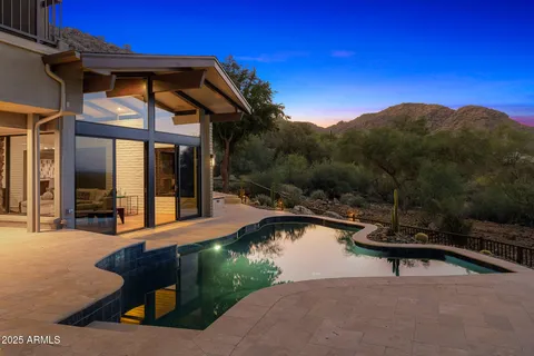 a swimming pool with outdoor seating and yard