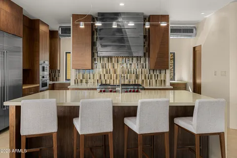 a kitchen with a table chairs stove and cabinets