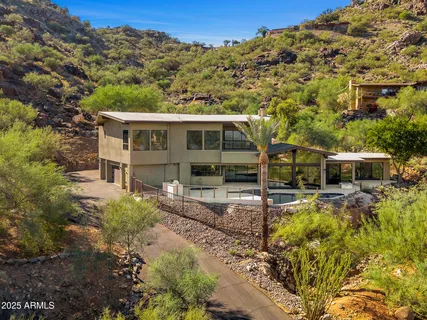 a view of a house with backyard and sitting area