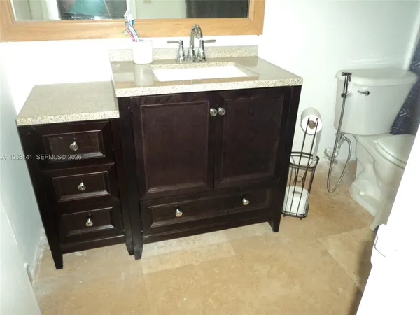 a bathroom with a sink vanity and a mirror