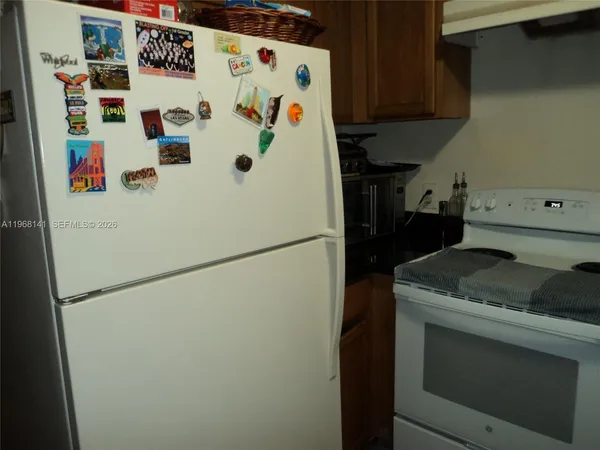 a white refrigerator freezer sitting inside of a kitchen