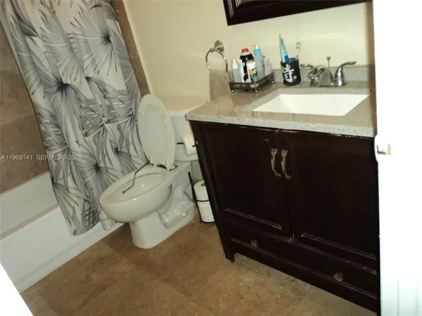 a bathroom with a sink toilet and mirror