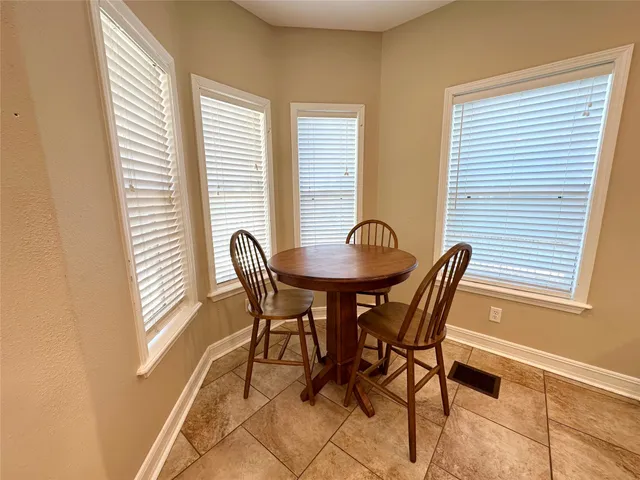 a view of a dining room with furniture and windows