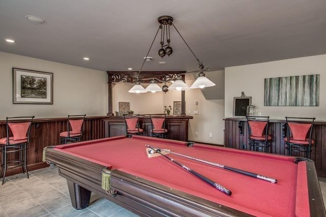 a room with pool table and flat screen tv