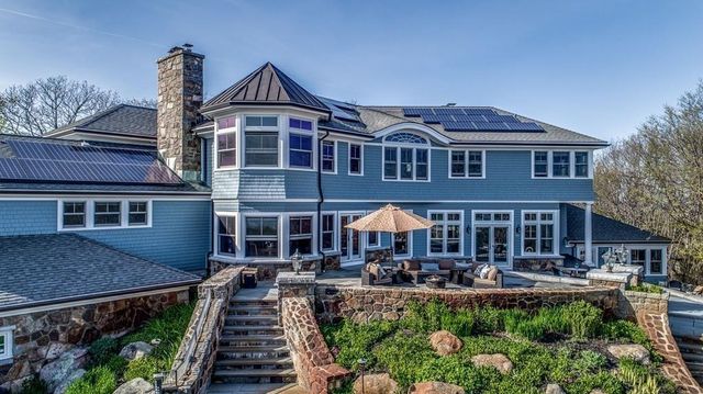 a front view of a house with yard and parking