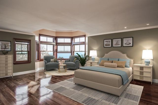 a spacious bedroom with a bed and glass walk in closet