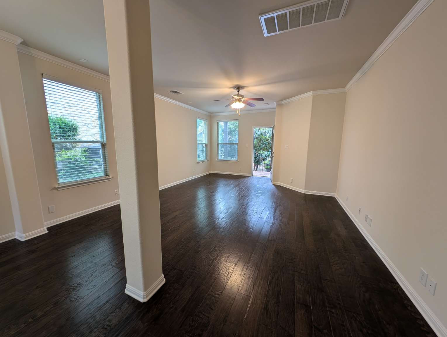 7301 Bandera Ranch Trail, Unit A Austin, TX 78750 - Photo 9 of 20 Rich hardwood floors flow through this welcoming living space, anchored by crown molding and natural light.